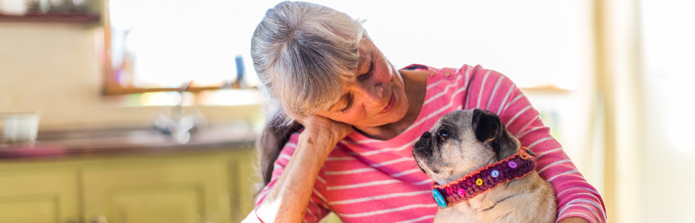 Mature woman holding her dog