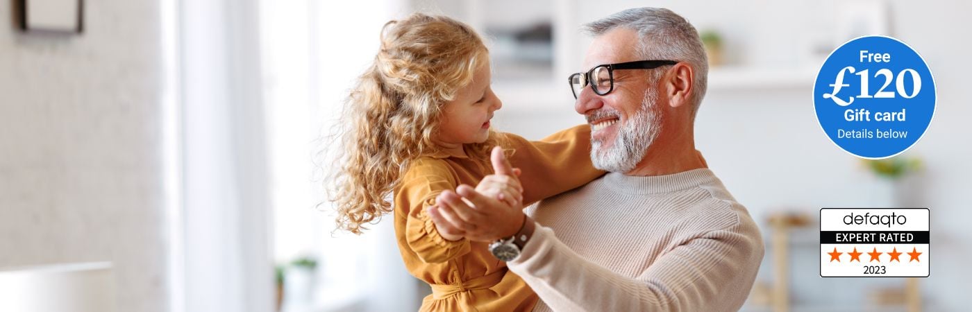 Grandad and grandaughter dancing and smiling. Over 50s  life insurance gift card offer