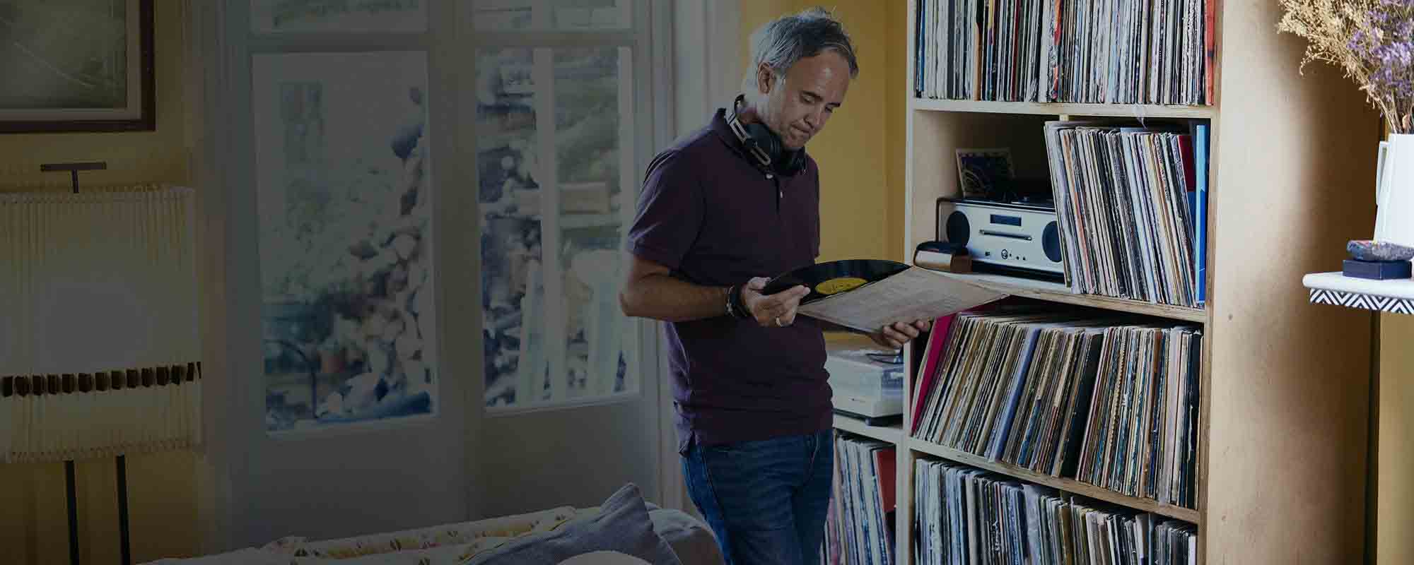 Man looking at his vinyl record collection